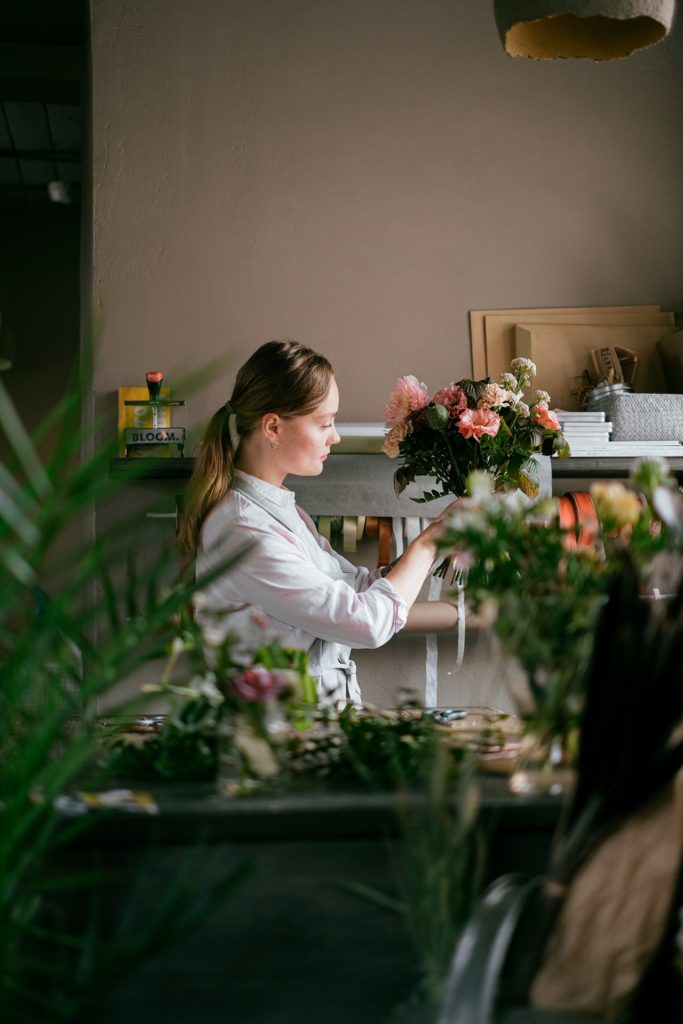 A female florist arranging a bouquet.